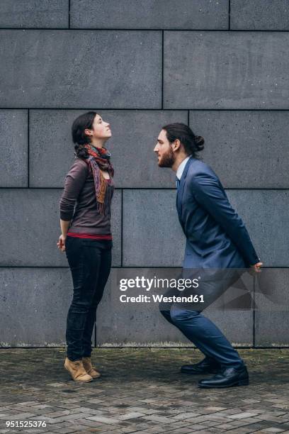 businessman standing opposite to woman - small man and tall woman stock pictures, royalty-free photos & images
