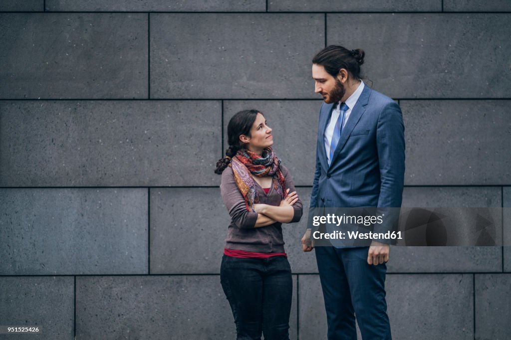Businessman and woman looking at each other