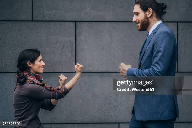 businessman and woman fighting - small man and tall woman stock pictures, royalty-free photos & images
