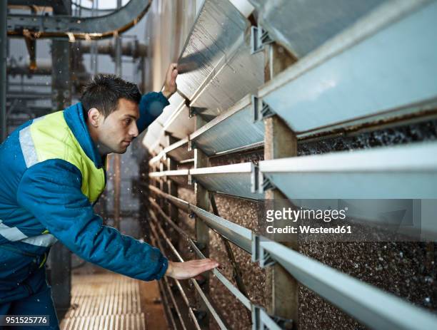 rumania, radauti, woodworking, worker checking cooling water of blast furnace - rumania - fotografias e filmes do acervo
