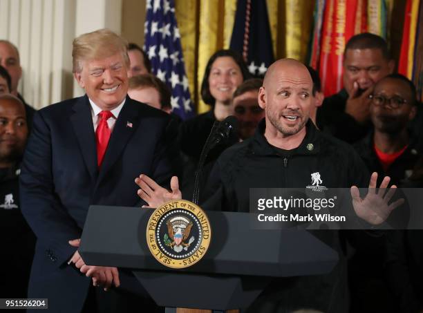 President Donald Trump listens to retired Army Staff Sergeant Dan Nevins speak during an event in the East Room of the White House recognizing the...
