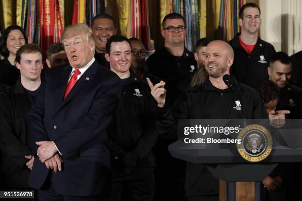 Dan Nevins, retired staff sergeant of the U.S. Army, right, speaks while U.S. President Donald Trump reacts during an event with the Wounded Warrior...