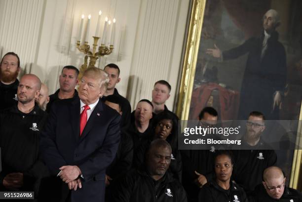 President Donald Trump, left, attends an event with the Wounded Warrior Project veterans to kick off the annual Soldier Ride in the East Room of the...