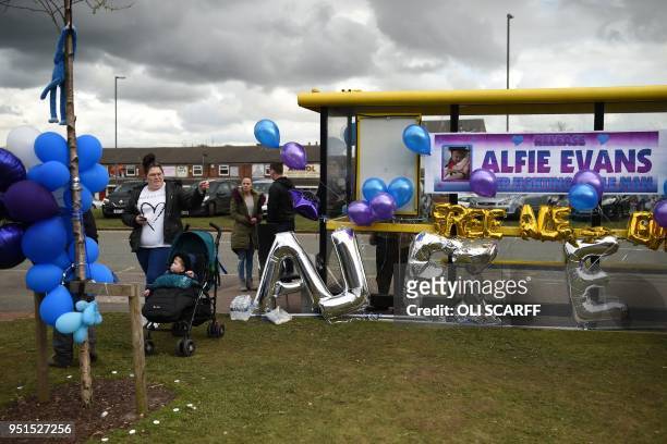 Supporters hang balloons and posters in support of British toddler Alfie Evans, on a bus-stop opposite Alder Hey childrens hospital in Liverpool,...