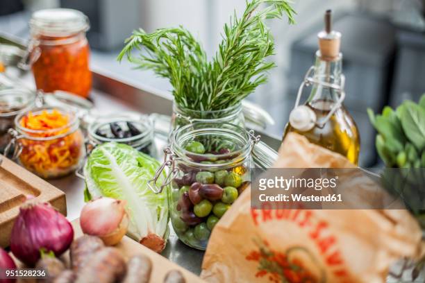 different ingredients, green olives in glass - mediterraanse gerechten stockfoto's en -beelden