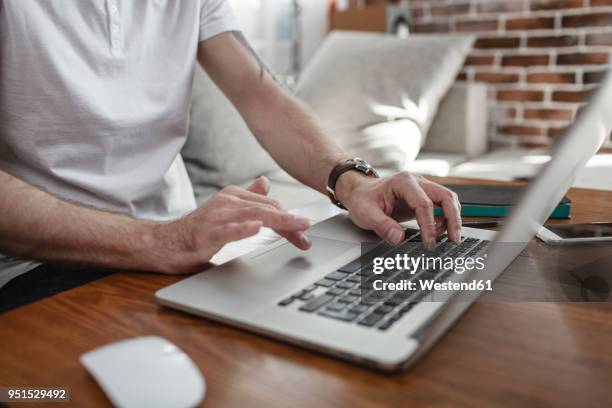 man's hands on keyboard and touchpad of laptop, partial view - touchpad stock pictures, royalty-free photos & images