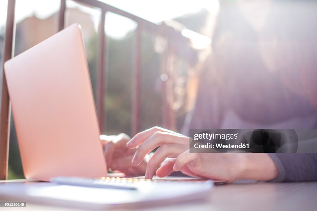 Woman's hand on laptop keyboard