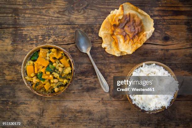 curry dish with cauliflower, butternut pumpkin, spinach and coriander, papadam and rice - cauliflower rice stock pictures, royalty-free photos & images