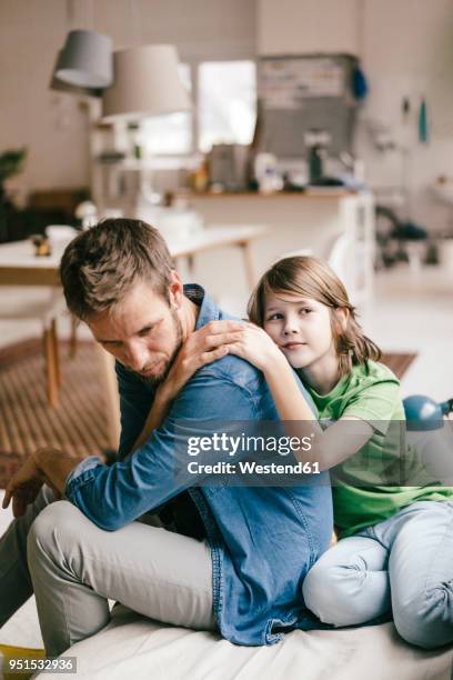 son consoling sad father at home - mourning parents stock pictures, royalty-free photos & images