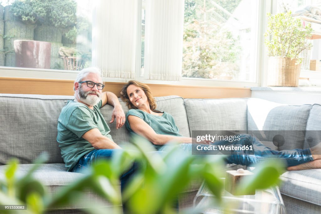 Mature couple relaxing on couch at home