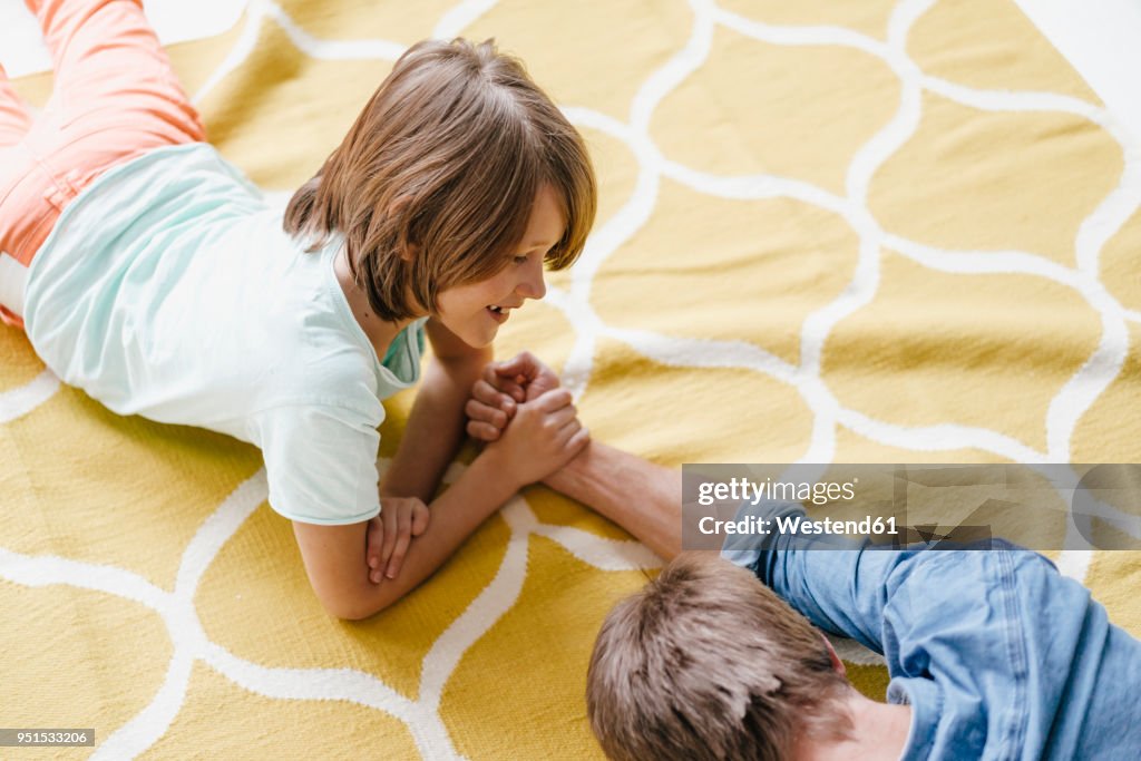 Son defeating father in arm wrestling