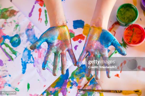 girl playing with finger paint - hands painting stock pictures, royalty-free photos & images