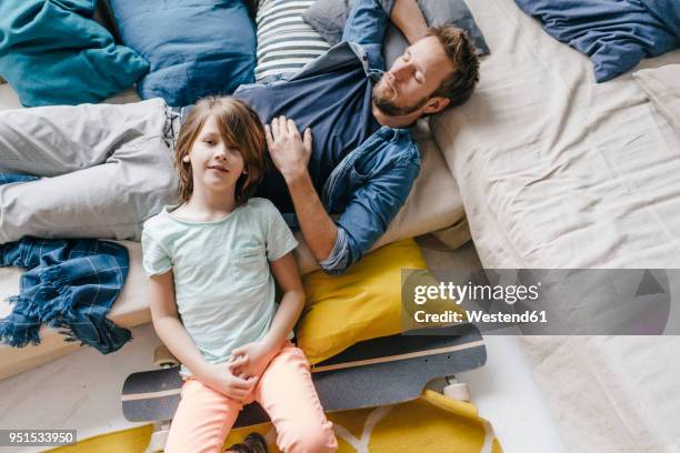 father and son with skateboard relaxing at home - father longboard stock pictures, royalty-free photos & images