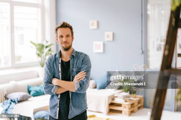 portrait of smiling man at home - platman stockfoto's en -beelden