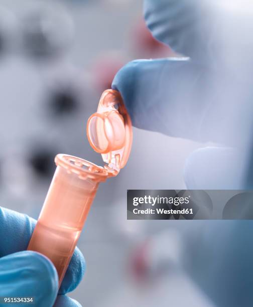 scientist closing the eppendorf tube - eppendorf tube stock pictures, royalty-free photos & images