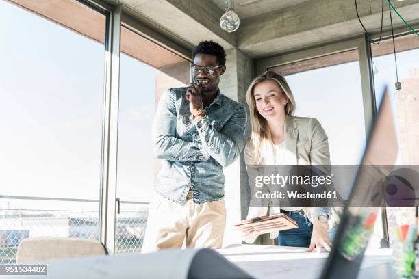 two colleagues working on plan at table in office - businessman looking at map stock pictures, royalty-free photos & images