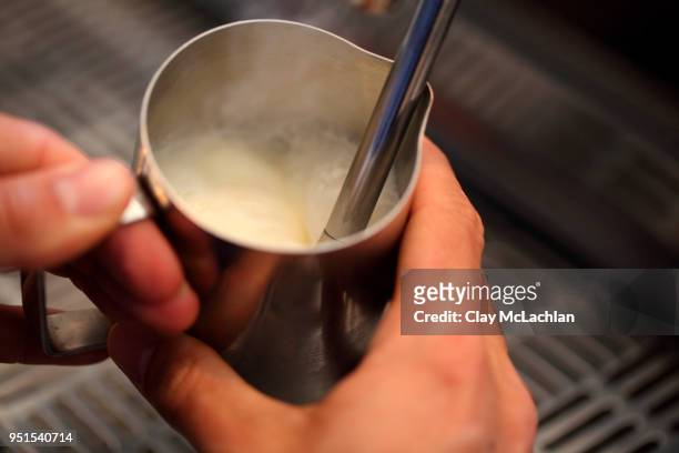 barista frothing or steaming milk in pitcher, san francisco, california, usa - milk pitcher ストックフォトと画像