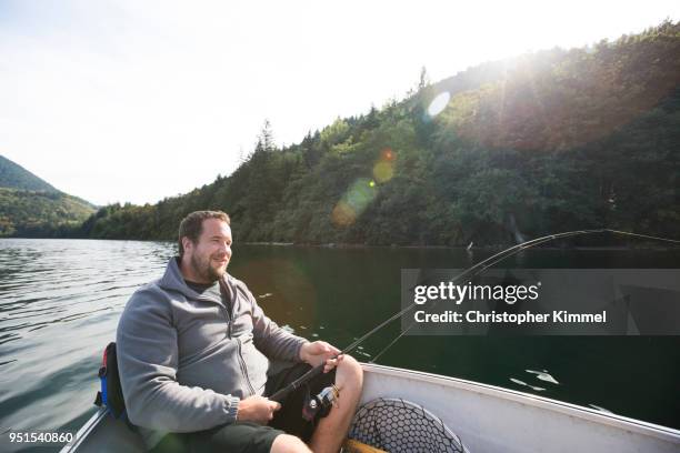 man fishing in hicks lake, harrison hot springs, british columbia, canada - angel hot stock-fotos und bilder