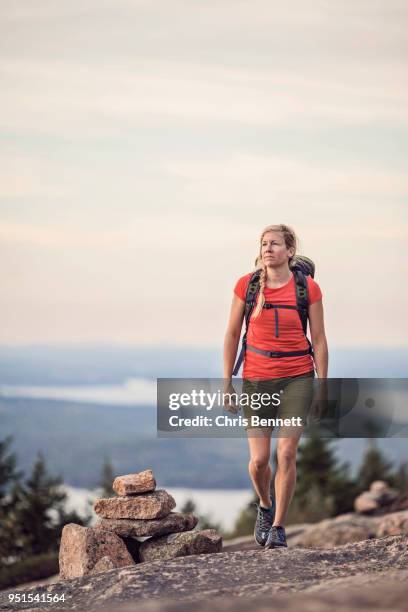 woman hiking at summit of pemetic mountain, acadia national park, maine, usa - acadia national park stock pictures, royalty-free photos & images