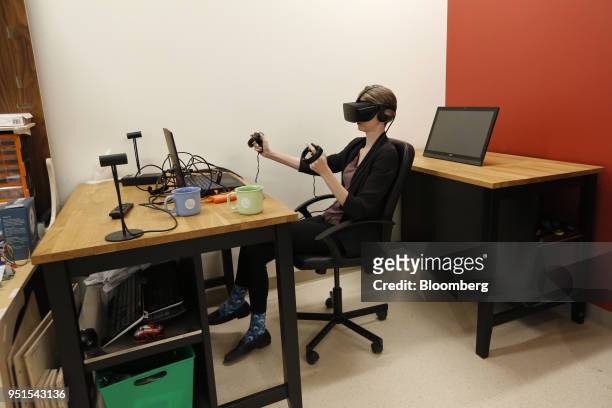 Tenant uses a virtual reality headset to manipulate a digital model at the Bayview Yards innovation center in Ottawa, Ontario, Canada, on Wednesday,...