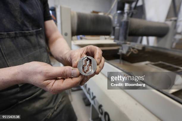 Technician displays the product of a water jet cutter in the maker space of the Bayview Yards innovation center in Ottawa, Ontario, Canada, on...
