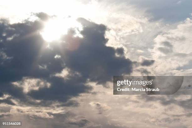 sun breaking through the  clouds - mammatus cloud stock pictures, royalty-free photos & images