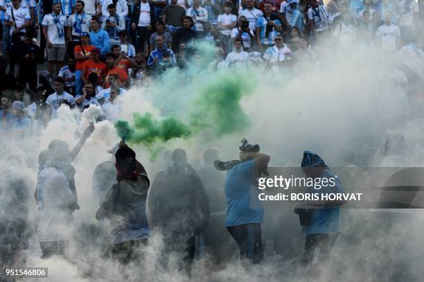 Marseille's supporters burn flares outside the Velodrome Stadium in Marseille, southeastern France, prior to the UEFA Europa League first-leg...