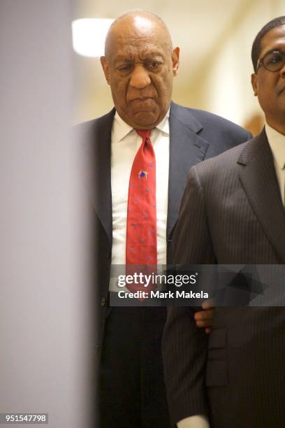 Bill Cosby walks after it was announced a verdict is in at the Montgomery County Courthouse for day fourteen of his sexual assault retrial on April...