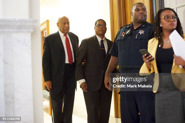 Bill Cosby walks after it was announced a verdict is in at the Montgomery County Courthouse for day fourteen of his sexual assault retrial on April...