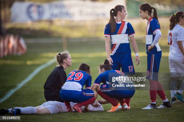 injury on women's soccer match! - soccer injury stock pictures, royalty-free photos & images