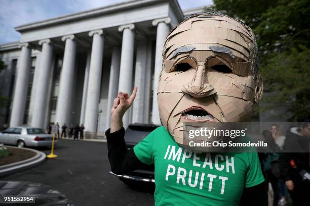 Lukas Ross of Friends of the Earth wears a giant mask of Environmental Protection Agency Administrator Scott Pruitt while protesting outside the...