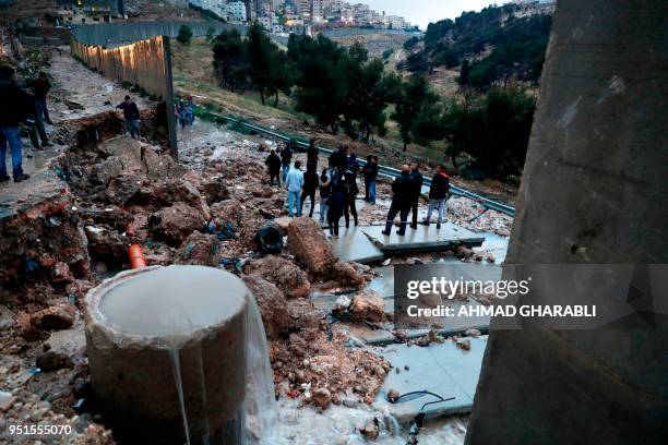 Picture taken on April 26, 2018 shows Palestinians from the Shuafat refugee camp in east Jerusalem standing on part of the controversial Israeli...