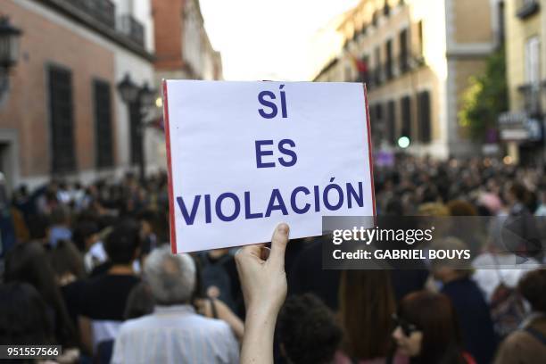 Person holds up a placard reading "Yes it is rape" during a demonstration in Madrid on April 26, 2018 to protest after five men accused of gang...