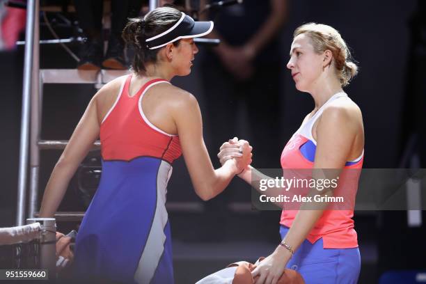 Garbine Muguruza of Spain shakes hands with Anastasia Pavlyuchenkova of Russia after retiring during day 4 of the Porsche Tennis Grand Prix at...