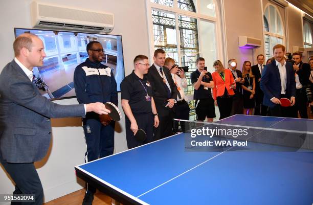 Prince William, Duke of Cambridge and Prince Harry play table tennis as they attend the opening of the Greenhouse Sports Centre on April 26, 2018 in...