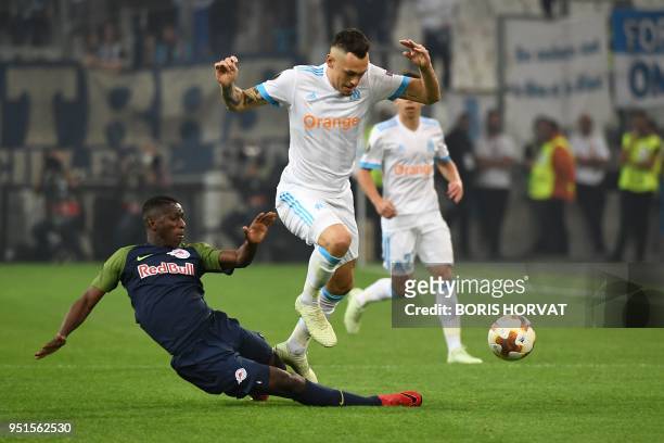 Marseille's Argentinian forward Lucas Ocampos is tackled by Salzburg's Malian midfielder Amadou Haidara during the UEFA Europa League first-leg...