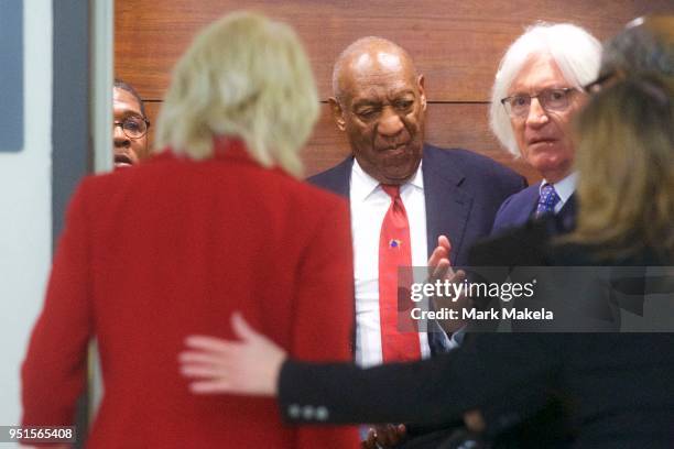 Bill Cosby descends an elevator with his attorney Tom Mesereau at the Montgomery County Courthouse after being found guilty on all counts in his...