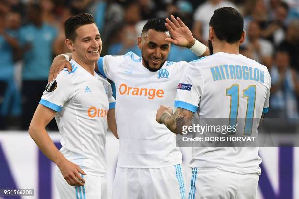 Marseille's French midfielder Florian Thauvin celebrates with Marseille's French forward Dimitri Payet and Marseille's Greek forward Konstantinos...