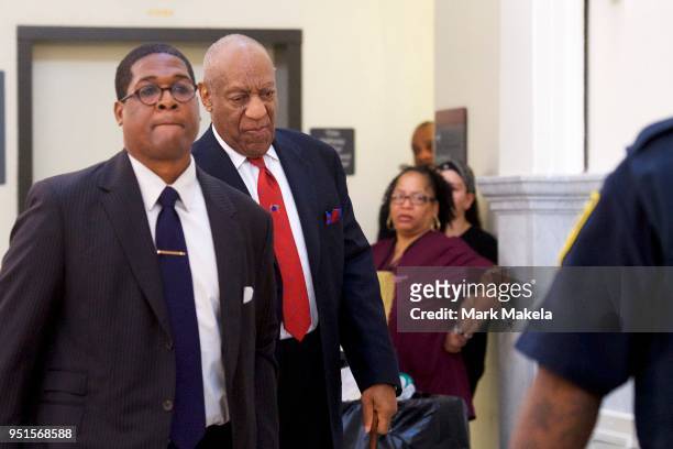 Bill Cosby walks through the Montgomery County Courthouse with his publicist, Andrew Wyatt, after being found guilty on all counts in his sexual...