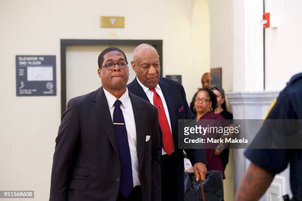 Bill Cosby walks through the Montgomery County Courthouse with his publicist, Andrew Wyatt, after being found guilty on all counts in his sexual...