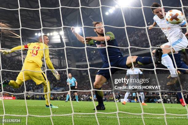 Marseille's French midfielder Florian Thauvin heads the ball and scores a goal during the UEFA Europa League first-leg semi-final football match...