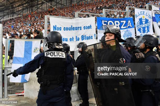 French riot police stand in position in front of Marseille's supporters southern stands during the UEFA Europa League first-leg semi-final football...