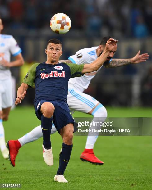 Stefan Lainer of FC Red Bull Salzburg controls the ball beside Kostas Mitroglou of Olympique de Marseille during the UEFA Europa League Semi Final...