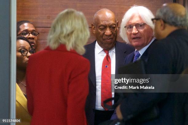 Bill Cosby descends an elevator with his attorney Tom Mesereau at the Montgomery County Courthouse after being found guilty on all counts in his...
