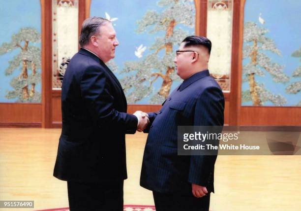 In this handout provided by The White House, CIA director Mike Pompeo shakes hands with North Korean leader Kim Jong Un in this undated image in...