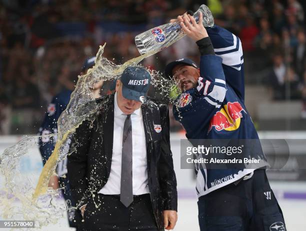 Team coach Don Jackson of EHC Red Bull Muenchen gets a beer shower from player Steven Pinizzotto after winning the German Championship title after...