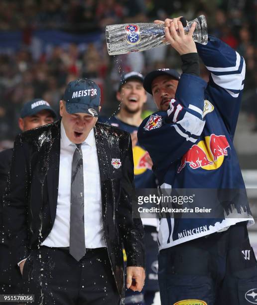 Team coach Don Jackson of EHC Red Bull Muenchen gets a beer shower from player Steven Pinizzotto after winning the German Championship title after...