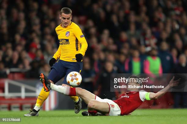 Antoine Griezmann of Atletico Madrid goes past Laurent Koscielny of Arsenal on his way to scoring his sides first goal during the UEFA Europa League...