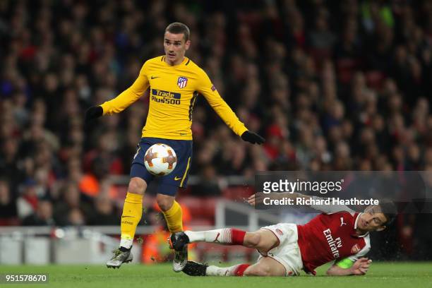 Antoine Griezmann of Atletico Madrid goes past Laurent Koscielny of Arsenal on his way to scoring his sides first goal during the UEFA Europa League...