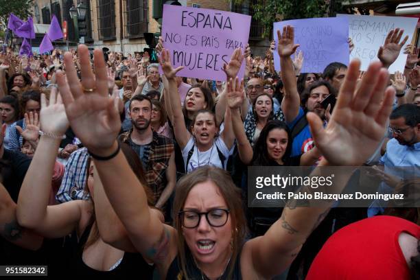 Protester holds a placard reading 'Spain is not a country for women' during a demonstration against the verdict of the 'La Manada' gang case outside...